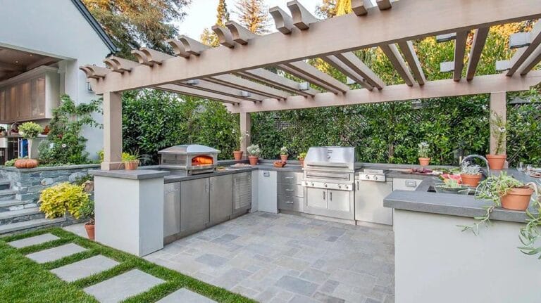 Outdoor kitchen under wood gazebo with stainless steel grill
