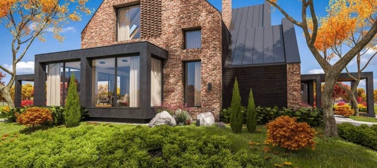 Large brick home with sloping lawn accented by colorful bushes and trees